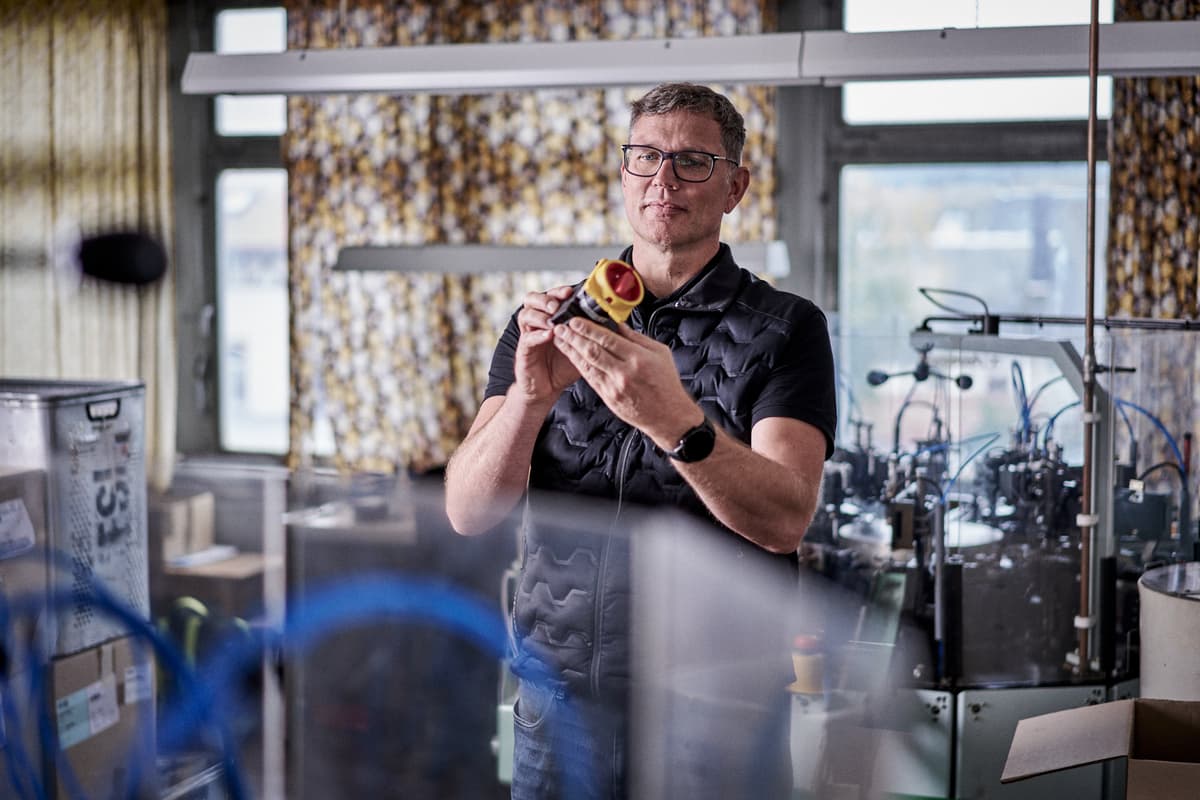 Ein Mitarbeiter von Sälzer, der einen Schalter in den Händen hält. 